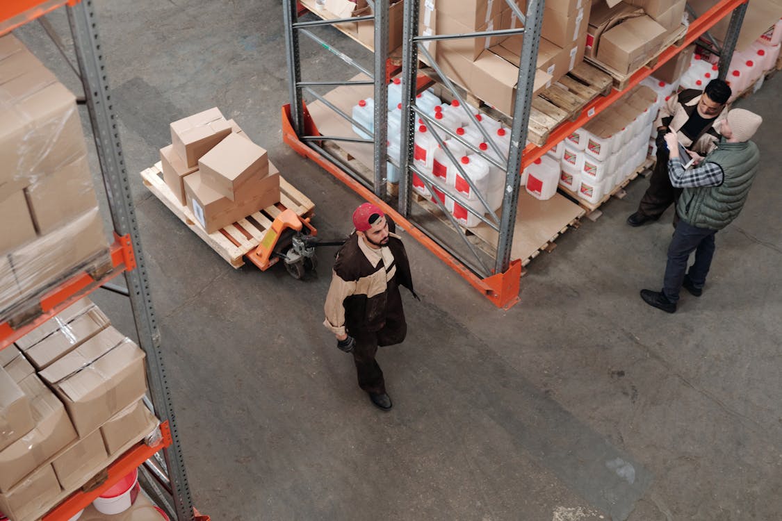AI Tools for Inventory Management in 2026: Reduce Stockouts and Cut Costs 1 Warehouse worker using tablet for AI-powered inventory management